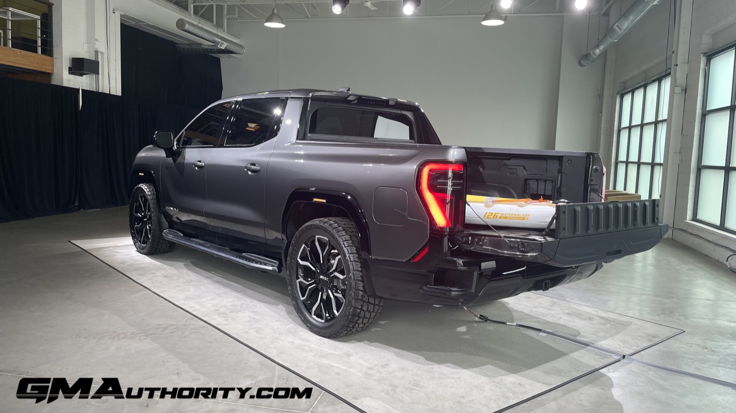 2024-GMC-Sierra-EV-Denali-Edition-1-Live-Photos-Exterior-020-side-rear-three-quarters-MultiPro...jpg